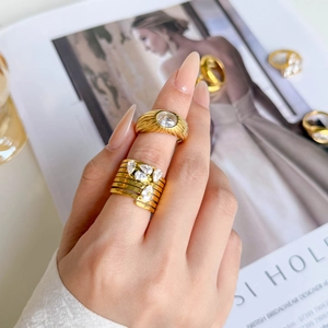 Golden titanium steel rings with oval zircons and double-layered crystal settings