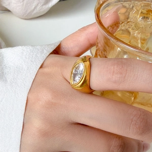 Close-up of a marquise-cut crystal ring in 18K gold plated steel on a finger