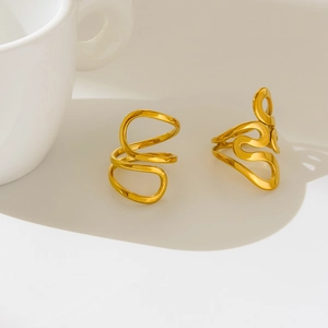 Detailed view of polished 18K gold plated titanium rings with elegant wavy curved design