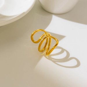 Close-up of hollow curved heart ring with 18K gold plating and wavy spiral layers