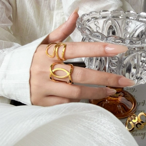 Curved geometric cutout heart rings in 18K gold plated stainless steel on model hand