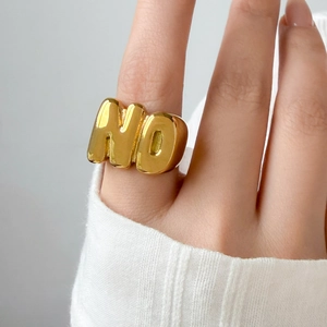 Detailed close-up of 18K gold-plated titanium steel ring with a 3D NO letter design