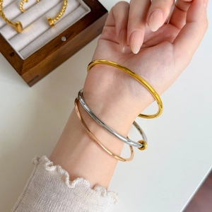 Minimalist screw style stainless steel bangles in gold, silver and rose gold finishes