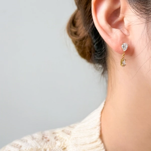 Elegant 18K gold plated titanium drop earrings featuring pear-shaped clear zircon stones