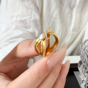 Detail of 18K gold-plated double-layer ring featuring two teardrop zircon stones