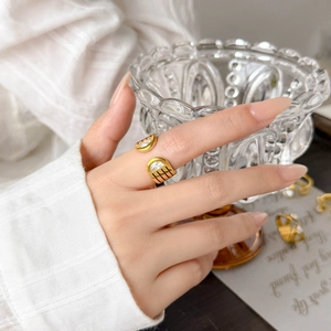 Detail of 18K gold-plated titanium ring with white zircon inlay and black stripes