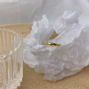 Detailed view of a golden olive leaf open ring with intricate vine texture engravings