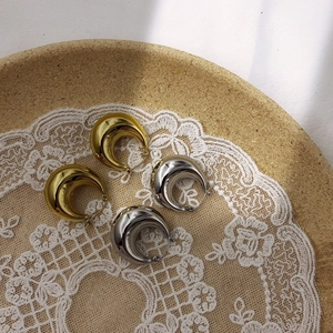 Elegant chunky hoop earrings in gold and silver finish with a polished mirror design