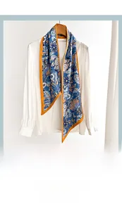Floral cotton-linen feel skinny scarf elegantly tied on a white shirt collar