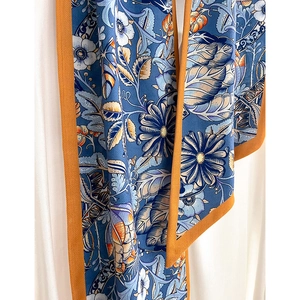 Floral cotton linen scarf in Prussian blue with orange edges and elegant botanical prints