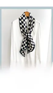 Close-up of black and white checkered neckerchief paired with a crisp white shirt