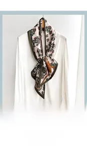 Close-up of retro floral and leopard print silk scarf with olive green contrast edges