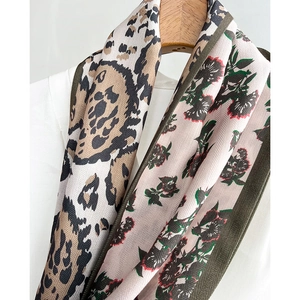 Double-sided fashion silk scarf with leopard print and floral patterns on a hanger