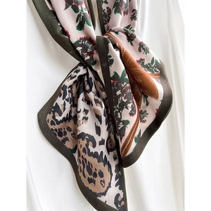 Elegant leopard and floral silk scarf with dark green border tied on white shirt
