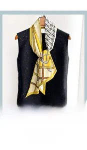 Detail of diagonal silk-feel neck scarf with mustard equestrian stirrup patterns