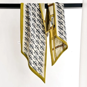 Elegant mustard yellow silk scarf with geometric shield pattern and smooth drape