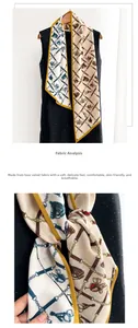 Detail of a beige skinny scarf with equestrian print and yellow border on a black dress