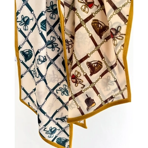 Elegant equestrian pattern silk scarf with yellow borders and detailed horse stirrup print