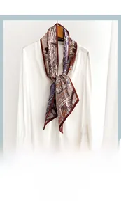 Close-up of vintage building print silk scarf tied as a necktie on a white shirt