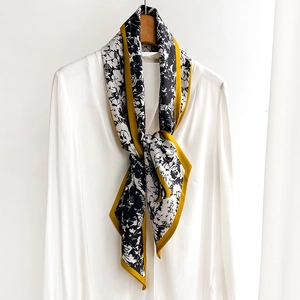 Elegant floral skinny scarf with mustard yellow trim tied on a white shirt