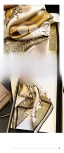 Détail macro d'un foulard en soie champagne montrant l'imprimé floral et les coutures fines