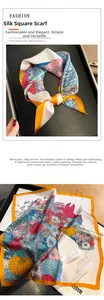 Détail d'un foulard carré en soie fleurie vintage avec bordure orange en coffret