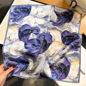 Purple floral silk square scarf with luxury print shown flat on elegant wood background