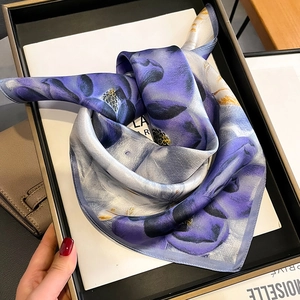 Elegant purple floral silk scarf folded in a gift box with a high-shine finish