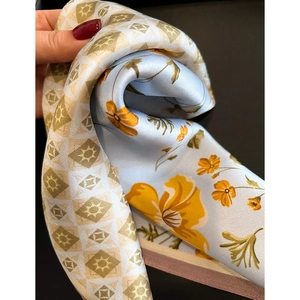 Elegant silk scarf featuring floral and checkered patterns with a satin finish texture