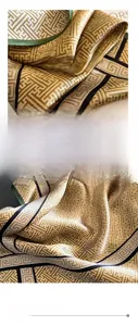 Detailed view of luxury silk scarf with geometric maze pattern and fine hemmed edges