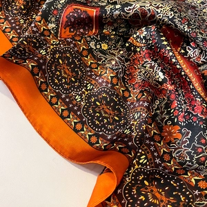 Elegant paisley silk scarf shawl in bright orange and black with retro floral patterns