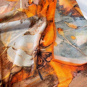 Artistic printed silk scarf with butterfly pattern and herringbone weave texture