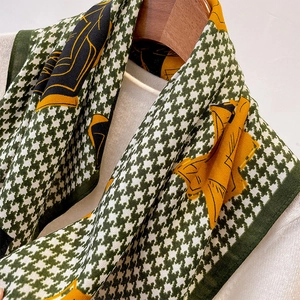 Detail view of houndstooth floral scarf with green patterns and hand-rolled edges