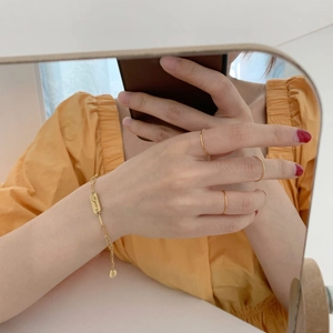 Minimalist gold thin ring set and engraved Lucky chain bracelet on hand