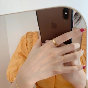 Golden irregular leaf chain ring and minimalist bracelet set shown in a mirror selfie