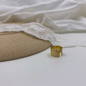 Minimalist wide gold band ring with diagonal textured pattern and adjustable open design