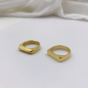 Minimalist geometric flat-top gold titanium steel rings shown from a 45-degree angle