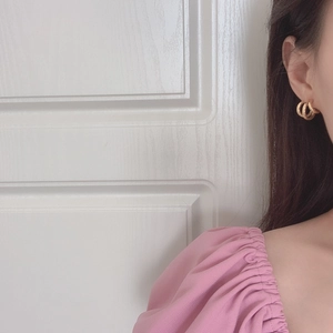 Elegant French irregular gold geometric multi-layer hoop earrings worn by a model