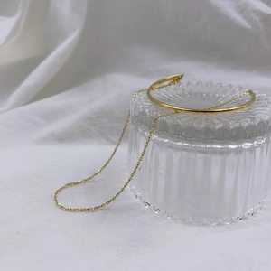 18K gold plated minimalist double layer chain bracelet on textured glass surface