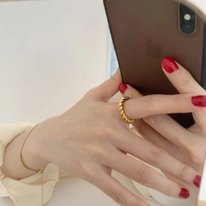 Golden twisted rope ring for women made of durable titanium steel with polished finish