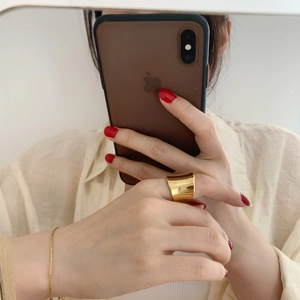 Golden mirror finish wide irregular ring and thin bracelet shown in mirror selfie