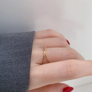 Minimalist gold double layer X-shaped cross ring worn on finger with chic jewelry style