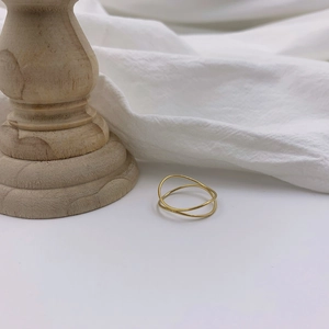 Minimalist double layer wavy gold ring for women displayed on a clean white background