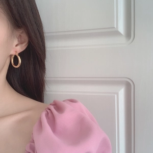 Minimalist thick gold round hoop earrings for women shown on model for elegant style