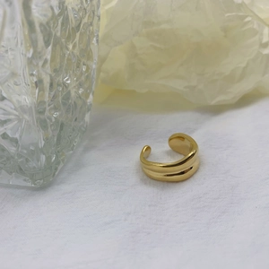 Detail shot of the golden double-ridged adjustable ring with mirror polished finish