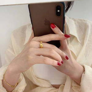 Détail d'une bague ouverte plaquée or avec finition polie et petite bille décorative