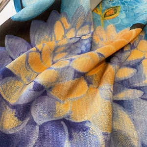 Artistic herringbone floral print scarf with vibrant blue and orange blooms and rolled edges