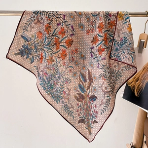Floral checkerboard pattern square scarf with burgundy border hanging on a metal rod