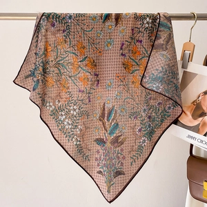 Detail of a vintage floral square scarf hanging with houndstooth pattern and silk texture