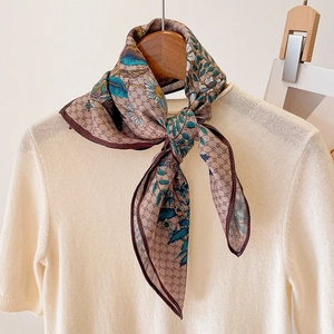 Elegant brown floral cotton-linen feel scarf styled on a sweater and wooden hanger
